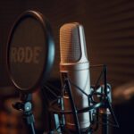 Close-up of a studio microphone with pop filter, ideal for recording audio.